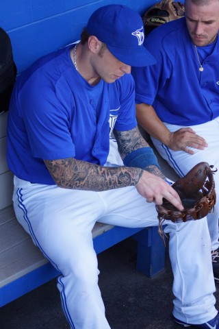 Brett Lawrie in the Dunedin dugout discussing his leather tool of the trade. (EDDIE MICHELS/PHOTO)