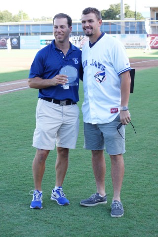 Toronto Blue Jays Florida Operations Director Shelby Nelson (L) presents RHP Taylor Cole with the team's 2014 Community Service award.  This was done prior to the Dunedin Blue Jays last home game of the regular season on August 27, 2014. (EDDIE MICHELS/PHOTO)