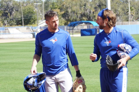 Josh Thole (L)  and veteran R.A. Dickey walk off the field at Florida Auto Exchange Stadium after their first long toss session of the spring.  Thole was seen wearing his new catchers mask catching Dickey's knuckler.  Perhaps Dickey is saying I'm not sure where the knuckler is going either.(EDDIE MICHELS PHOTO)