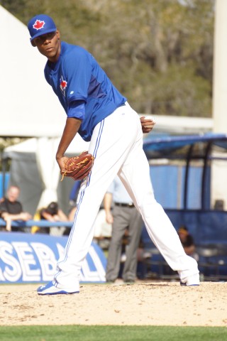 Blue Jays prospect Miguel Castro gave a death stare to the runner at first during his one inning of work against the Pirates on Tuesday.  At six feet seven inches the 20-year old is quite impressing on the mound. (EDDIE MICHELS/PHOTO)
